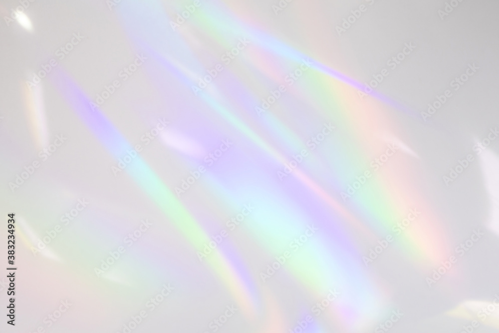 Blurred rainbow light refraction texture overlay effect for photo and mockups. Organic drop diagonal holographic flare on a white wall. Shadows for natural light effects Blurred rainbow light refraction texture overlay effect for photo and mockups. Organic drop diagonal holographic flare on a white wall. Shadows for natural light effects
