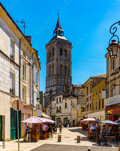 Fototapeta Naklejka Na Ścianę i Meble -  Central street of French town of Cognac overlooking bell tower of Saint Leger Church