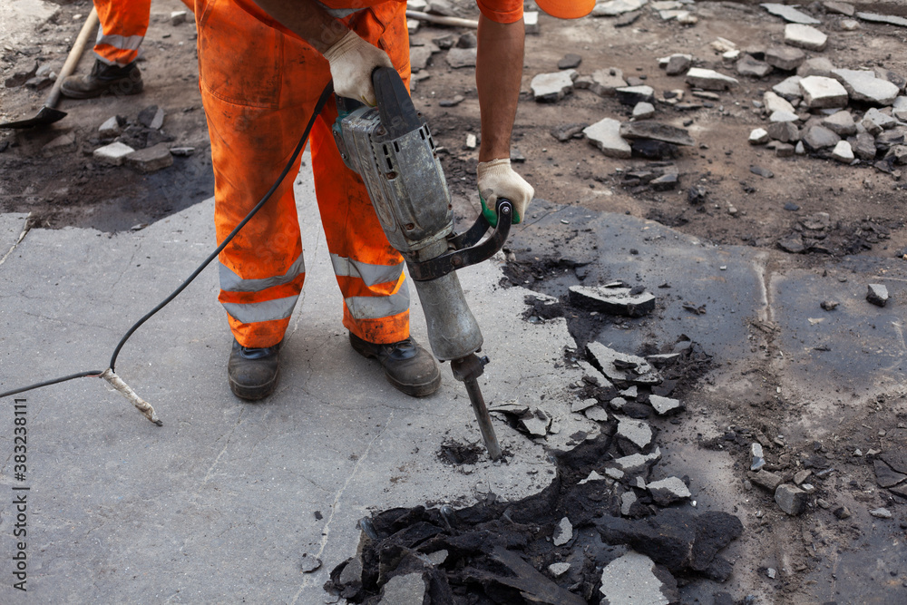 Working with a jackhammer. Removal of asphalt. Change of road surface. Working with a jackhammer. Removal of asphalt. Change of road surface.