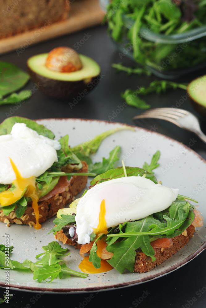 Homemade sandwiches with salmon, avocado and poached eggs