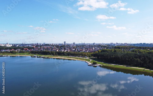 Top view of a beautiful city summer park with a lake and an embankment. 