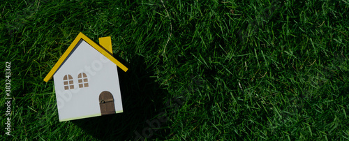 Miniature house on the lawn. Home, new construction, living environment, livability, family, etc.芝生の上のミニチュアの家。家、新築、住環境、住みやすさ