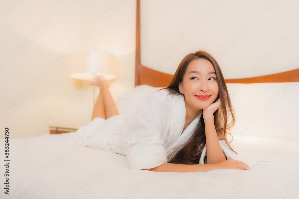 Portrait beautiful young asian woman smile relax on bed in bedroom interior Portrait beautiful young asian woman smile relax on bed in bedroom interior