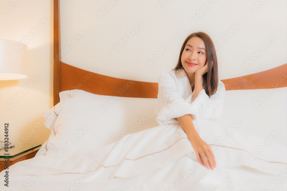 Portrait beautiful young asian woman smile relax on bed in bedroom interior Portrait beautiful young asian woman smile relax on bed in bedroom interior