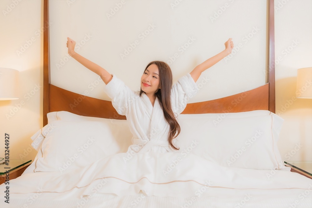 Portrait beautiful young asian woman smile relax on bed in bedroom interior Portrait beautiful young asian woman smile relax on bed in bedroom interior