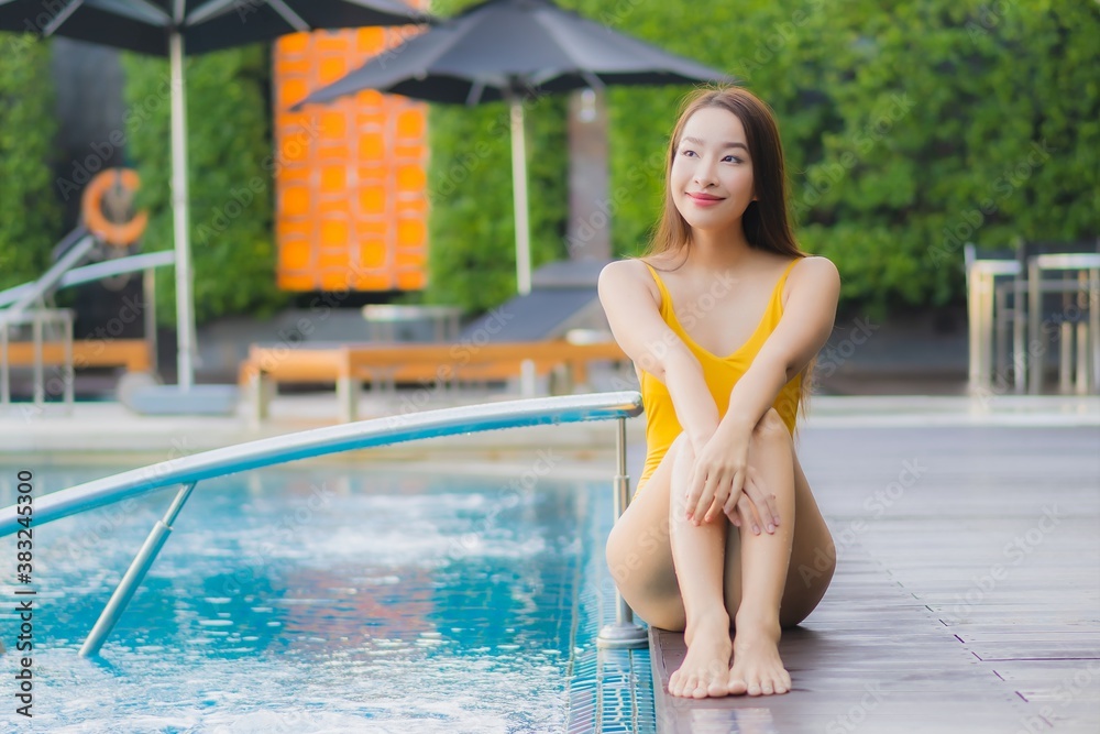 Portrait beautiful young asian woman relax smile leisure around outdoor swimming pool