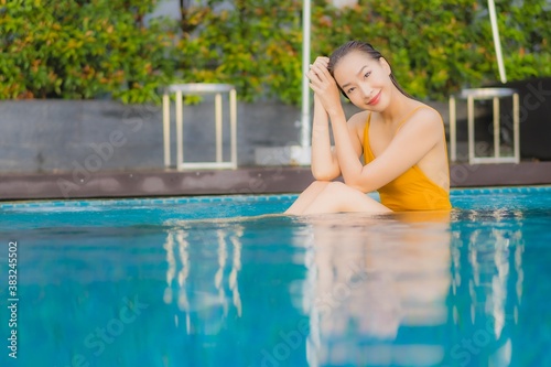 Portrait beautiful young asian woman relax smile leisure around outdoor swimming pool