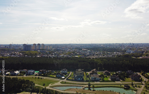 Top view of suburban area with trees and pond