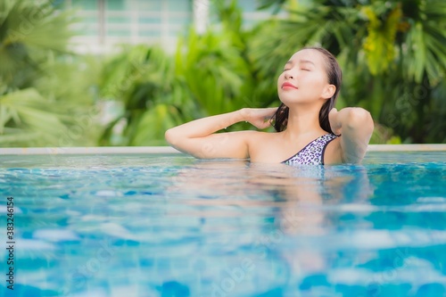 Portrait beautiful young asian woman relax smile leisure around outdoor swimming pool © siraphol