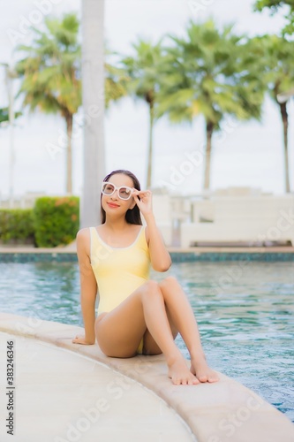 Portrait beautiful young asian woman relax smile leisure around outdoor swimming pool