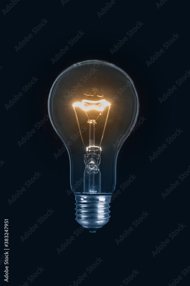 Glowing light bulb close up on black background Glowing light bulb close up on black background