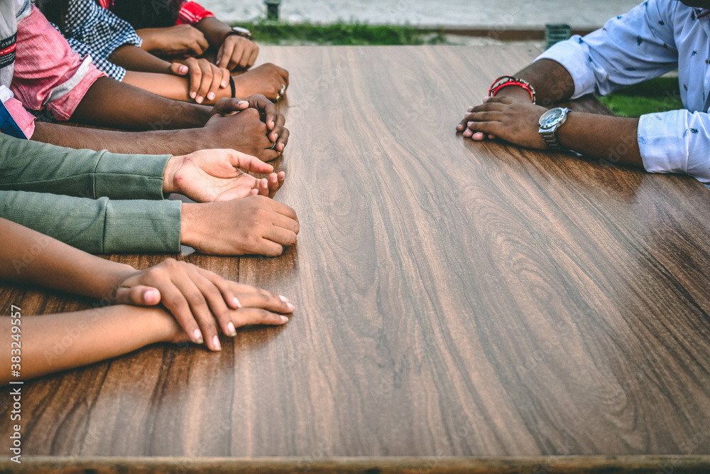 Fototapeta premium Many hands of different skin tone resting on table. Concept of equality in diversity. Concept of success in togetherness