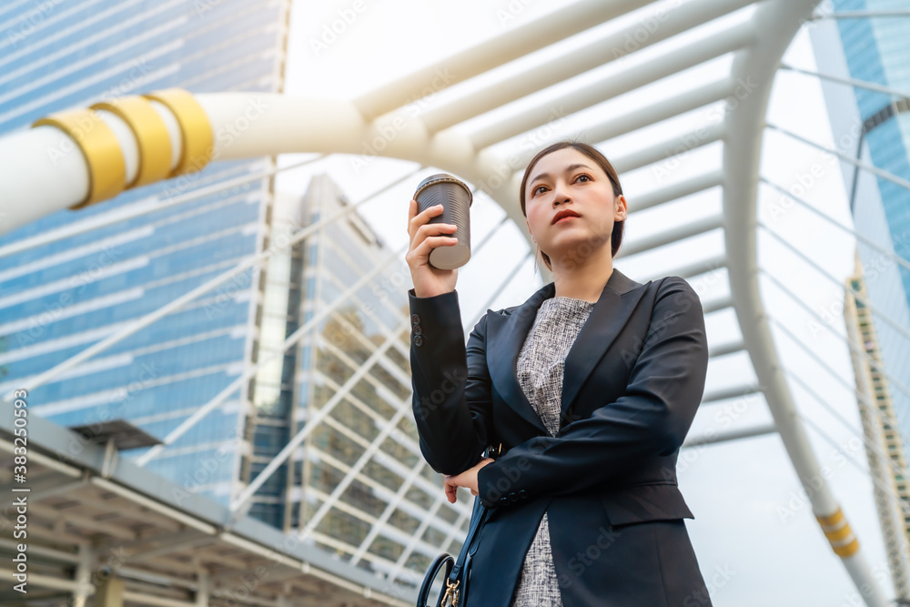 woman holding a cup of coffee and thinking about problem of her business in city woman holding a cup of coffee and thinking about problem of her business in city