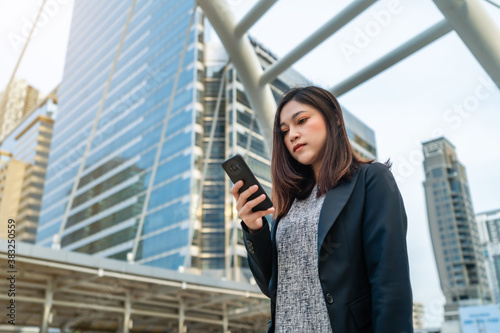 business woman using smartphone in city © geargodz