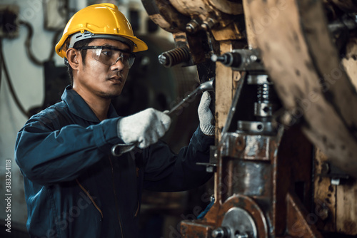 Photography Asian engineer mechanic man checking and using wrench for maintenance pressing m