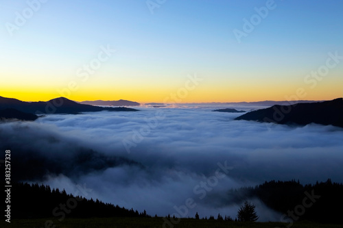 Majestic sunrise in the mountains landscape, beautiful dawn with fog