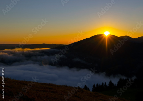Majestic sunrise in the mountains landscape, beautiful dawn with fog