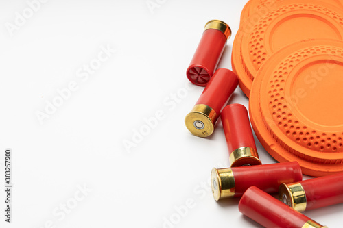 Fotografie, Obraz Clay disc flying targets and shotgun bullets on white background ,Clay Pigeon ta