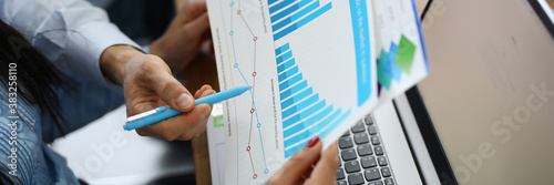 Quadro em tela Female and male hand holding graph with financial performance at the workplace