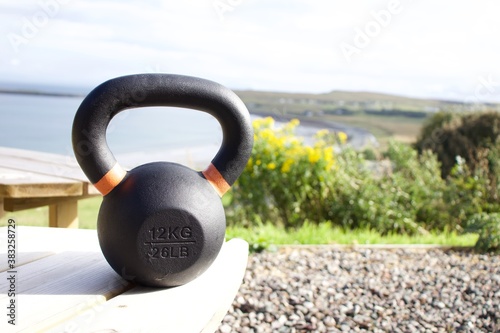 Exercising outdoors with a kettlebell, with a view