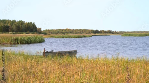 Svyatoe lake in the Meshchersky region in Russia with A broken boat in the foreground. photo