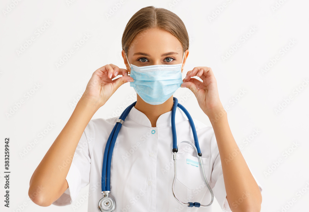 concept of fighting and prevention coronavirus infection covid 19. a doctor put on protective medical mask . concept of fighting and prevention coronavirus infection covid 19. a doctor put on protective medical mask .