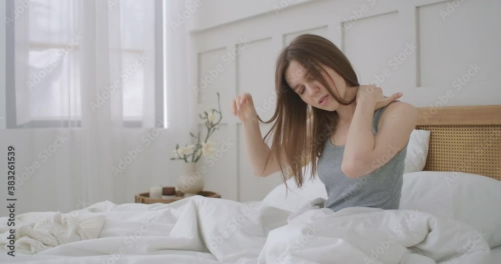 Woman waking up and having pain in shoulder and neck. Woman waking up and having pain in shoulder and neck Woman waking up and having pain in shoulder and neck. Woman waking up and having pain in shoulder and neck