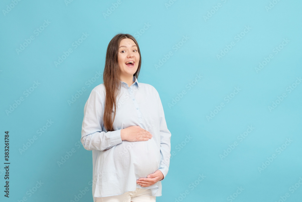 young pregnant woman on blue background in blue clothes young pregnant woman on blue background in blue clothes
