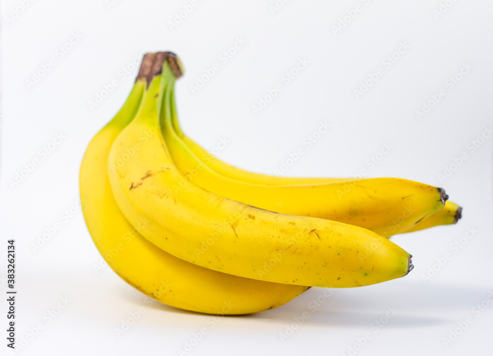 Ripe yellow bananas.A bunch of ripe bananas with dark spots on a white background.