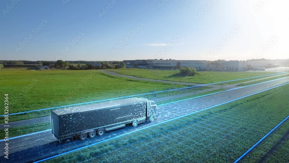 Futuristic High-Tech Concept: Big Semi Truck with Cargo Trailer Drives on the Road is Transformed with Graphics Special Effects Into Digitalized Advanced Autonomous Truck Concept. Aerial Drone Shot