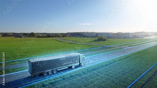 Futuristic High-Tech Concept: Big Semi Truck with Cargo Trailer Drives on the Road is Transformed with Graphics Special Effects Into Digitalized Advanced Autonomous Truck Concept. Aerial Drone Shot