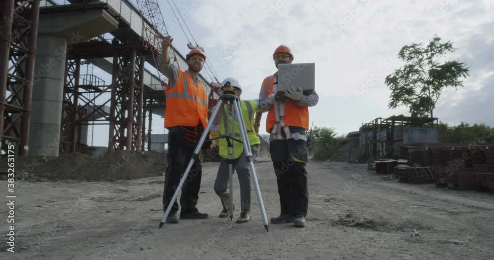 Contractors working on plan of construction Contractors working on plan of construction