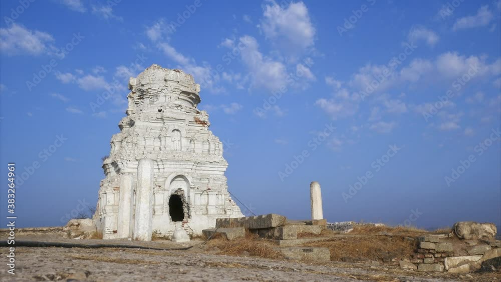 Timelapse of passing clouds in the blue sky over a white Hindu temple in Hampi, India Timelapse of passing clouds in the blue sky over a white Hindu temple in Hampi, India
