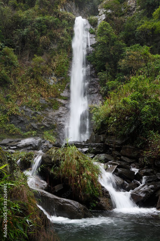 Waterfall and green vegetation Waterfall and green vegetation