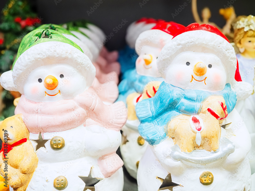 White ceramic decorative snowmen figurines with star-shaped slots. Decorative Christmas Lights