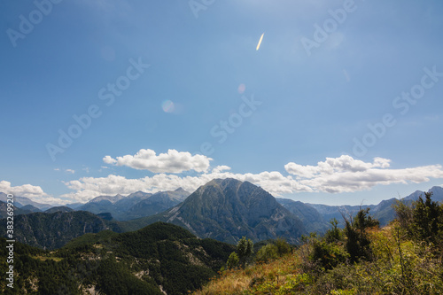 Clouds above mountain peaks in a sunny day