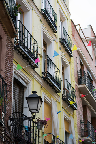 Garlands hanging from balconies between buildings