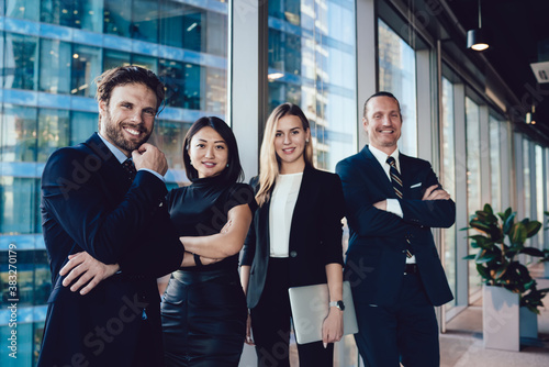 Cuadro en lienzo Delighted business people in formal wear standing together and looking at camera