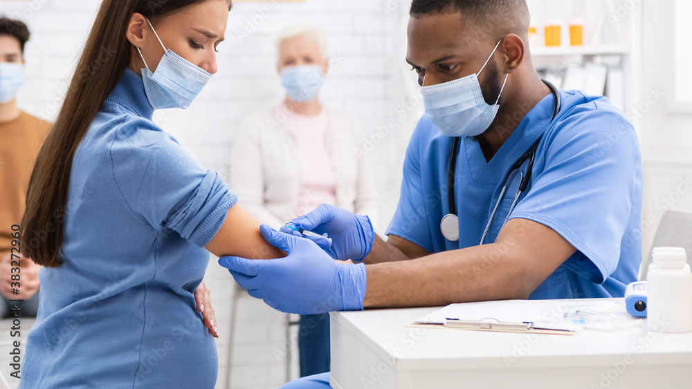 Pregnant Lady In Mask Receiving Coronavirus Vaccine Injection In Hospital Pregnant Lady In Mask Receiving Coronavirus Vaccine Injection In Hospital