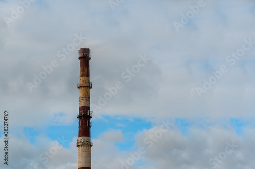 industrial chimney on the background of the sky with clouds.