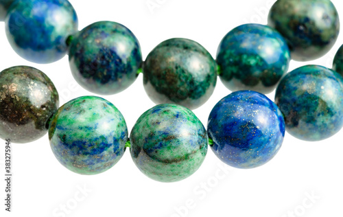 two strings from polished azurite with malachite balls close up isolated on white background