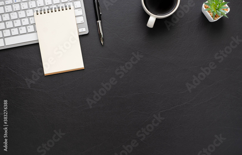 Obraz na plátně Black office desk table with keyboard, notebook and coffee cup with equipment office supplies