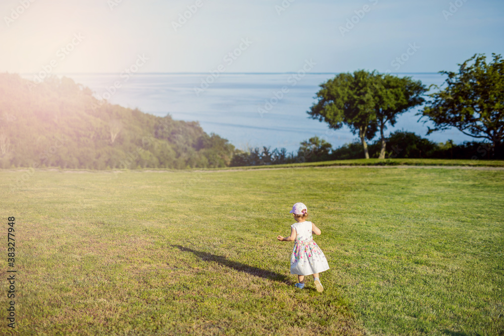 Smiling girl on the meadow looking right at camera Smiling girl on the meadow looking right at camera