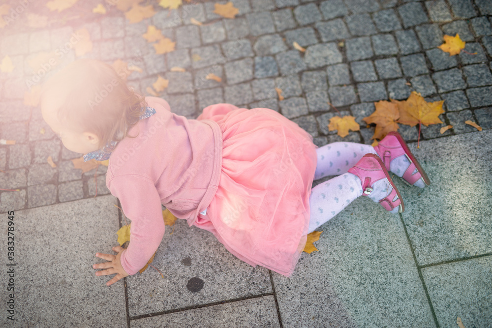 Naklejka premium Little girl spending fantastic time on playground. Happy childhood. Authentic image.