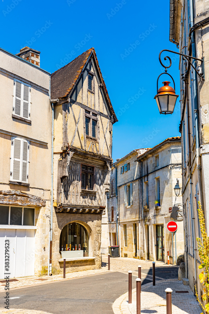 Typical narrow cobbled street in Cognac Old Town on summer day, France