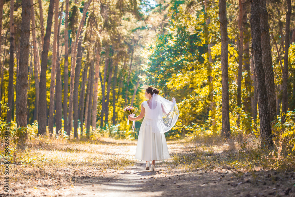 happy bride with a bouquet is walking the green park happy bride with a bouquet is walking the green park