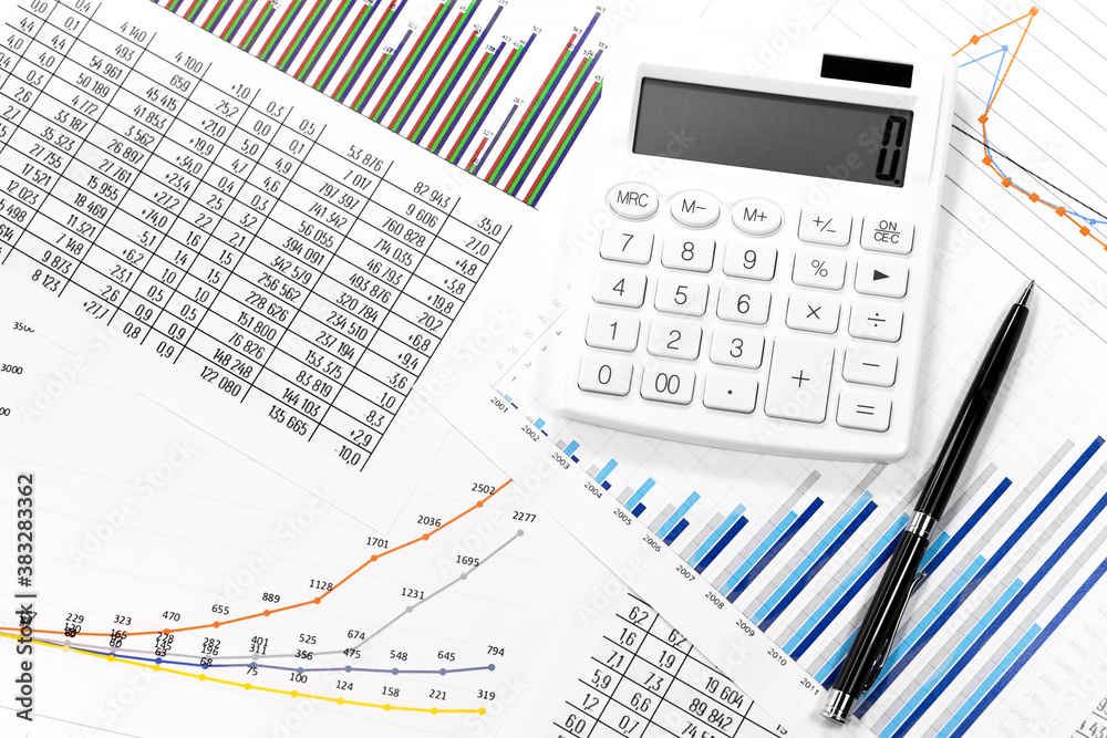 White calculator, coins and black pen on against the background of documents. Financial bookkeeping, Accounting Concept. Top view. White calculator, coins and black pen on against the background of documents. Financial bookkeeping, Accounting Concept. Top view.