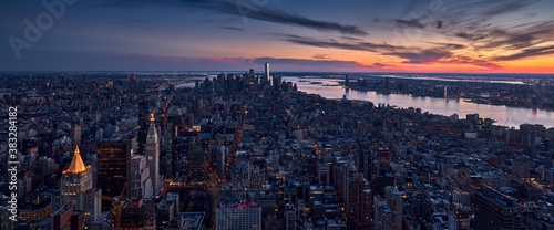 Aerial panoramic skyline of a New York City Sunset over the skyscrapers of Manhattan. Cityscape of Midtown, Lower Manhattan, Financial District and the Hudson River. NYC, USA