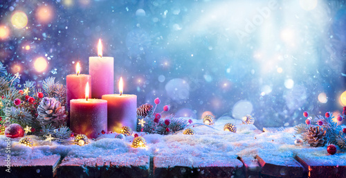 Advent - Four Purple Candles With Christmas Ornament In Shiny Night photo