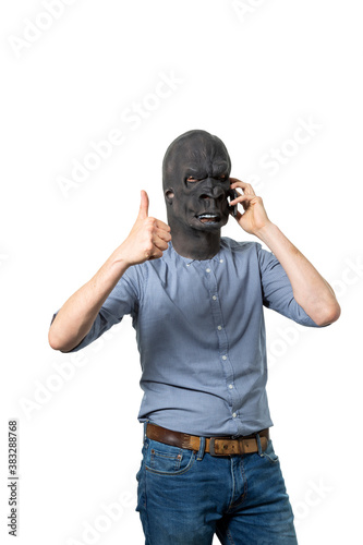 Man in Gorilla Mask Talking on Cell Phone Giving the Thumbs Up